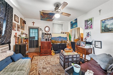 Living room with wood finished floors and ceiling fan