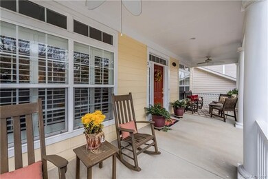 2 seating areas and ceiling fan on front porch.