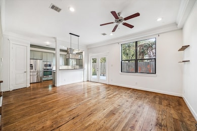 Spacious open-concept living and dining area that flows seamlessly into the kitchen, providing incredible first-floor living and direct access to the large backyard.