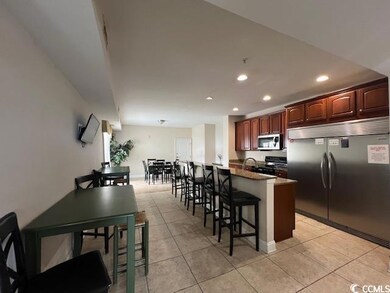 Kitchen with a kitchen island, appliances with sta
