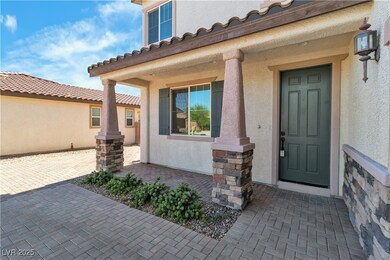 View of exterior entry with stucco siding, a porch