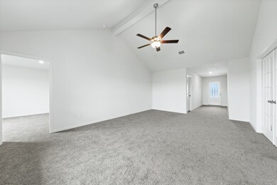 Empty room with beamed ceiling, light carpet, a ceiling fan, and high vaulted ceiling