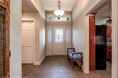 Elegant front entry with transom leads to the open