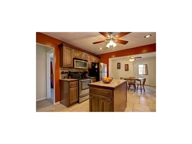 Stainless steel appliances and neutral tile floors