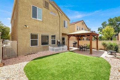 Back of house featuring a gazebo, stucco siding, a