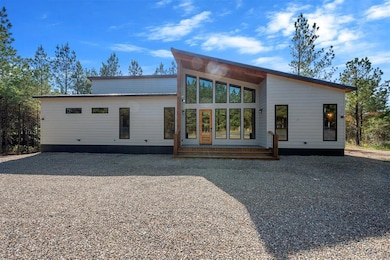 Back of house featuring a wooden deck