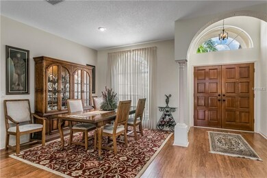 Formal dining room and foyer with attractive lamin