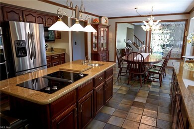Jenn Air range and granite top ceramic flooring stainless steel appliances.