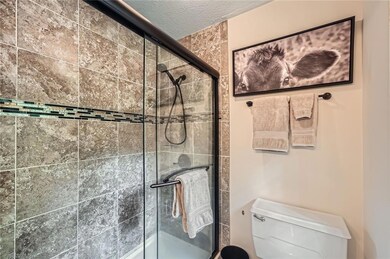 The primary bedroom has it's own private bathroom with this spa-like shower.