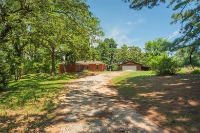 View of front facade with a garage and an outdoor 