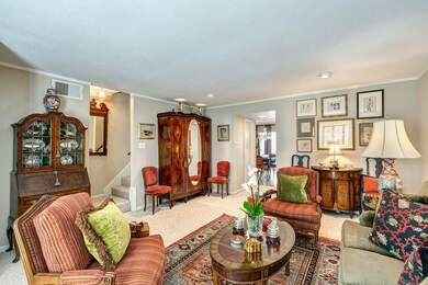Living area with a view of the dining room and sta