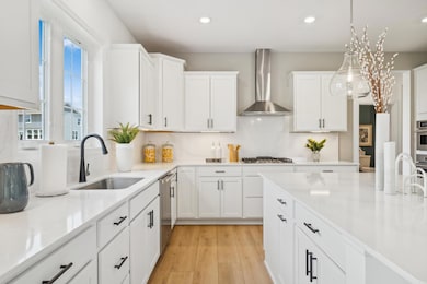 (Photo of model home, finishes will vary) The kitchen overlooks the open layout for easy entertaining