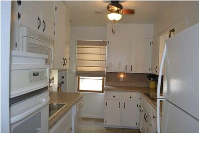 Kitchen with newer tiled back splash and floors. U
