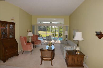 Living room with sliders to lanai and pool