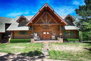 Front entryway of home. Original 10 inch aged logs