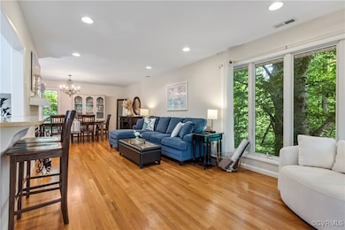 Living room with light hardwood / wood-style floor