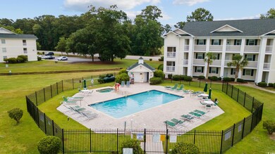 View of pool featuring a patio and a lawn
