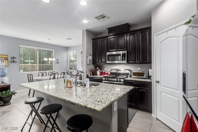 Kitchen with a sink, a kitchen breakfast bar, stai