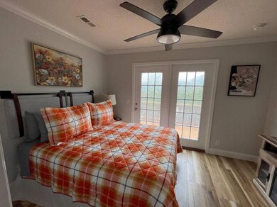 Bedroom featuring access to outside, light wood fi