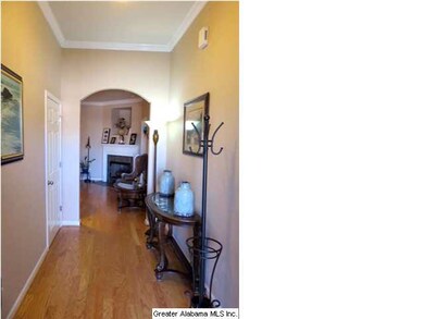 The welcoming entry has hardwood floors and showca