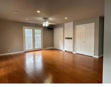 Unfurnished bedroom featuring two closets, wood f
