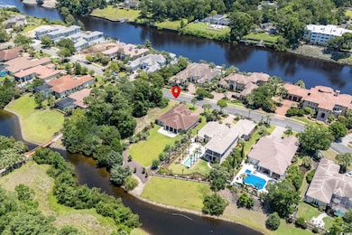 Aerial view of property's location featuring nearby suburban area and a large body of water