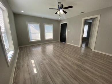 Unfurnished room featuring dark hardwood / wood-style floors and ceiling fan
