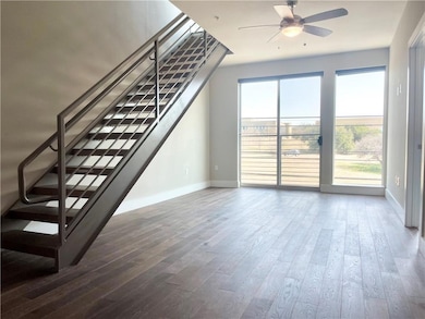 Unfurnished living room featuring a ceiling fan, 