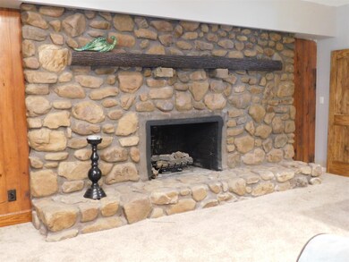 Close-up of beautiful, large stone fireplace with gas logs.