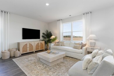 Living room with recessed lighting, wood finished floors, and visible vents