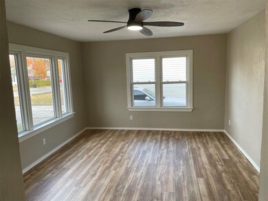 Empty room with ceiling fan and dark wood-type flo
