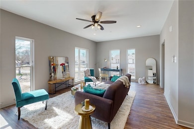 Living room featuring baseboards, recessed lightin