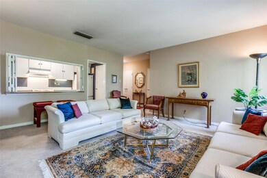 Living area showing kitchen and entry hall in back