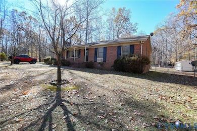 Ranch-style house with brick siding