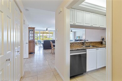 Kitchen with stainless steel dishwasher, dark ston