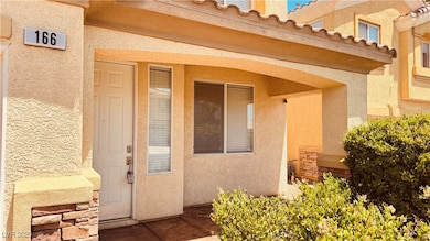 Property entrance featuring stucco siding