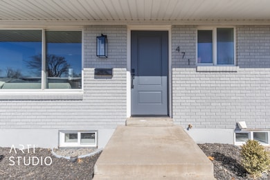 Doorway to property with brick siding and a porch