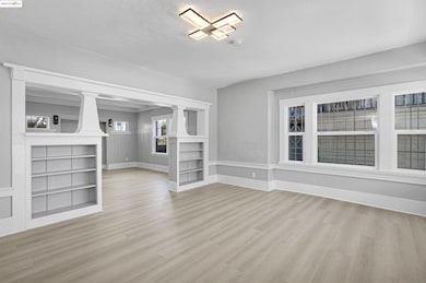 Unfurnished living room featuring wood finished floors