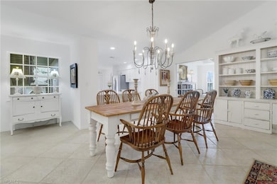 Dining area featuring a chandelier and vaulted cei