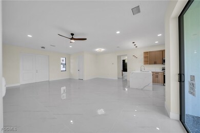 Unfurnished living room with recessed lighting, a ceiling fan, and light marble finish flooring