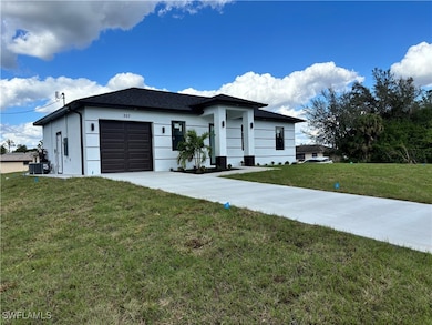 View of front of house with a garage, a front yard