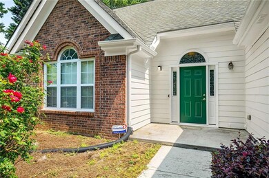 Property entrance with brick siding and a shingled roof