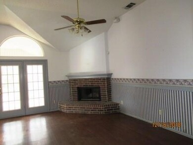 Den off kitchen/nook with corner brick fireplace