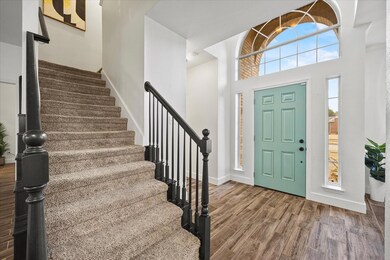 Entrance foyer featuring a towering ceiling and wo