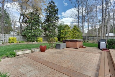 View of patio with a garden, a fenced backyard, ar