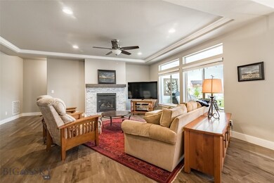 Living room features; gas fireplace, a coffered ce
