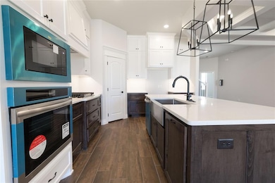 Kitchen featuring stainless steel gas cooktop, whi