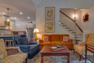 Living area featuring stairs and recessed lighting
