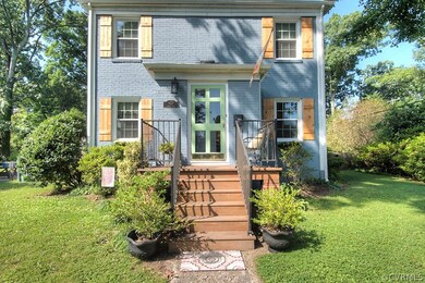 The bright front door offers a friendly welcome to