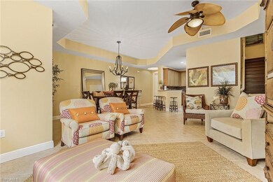 Living area with ceiling fan with notable chandeli